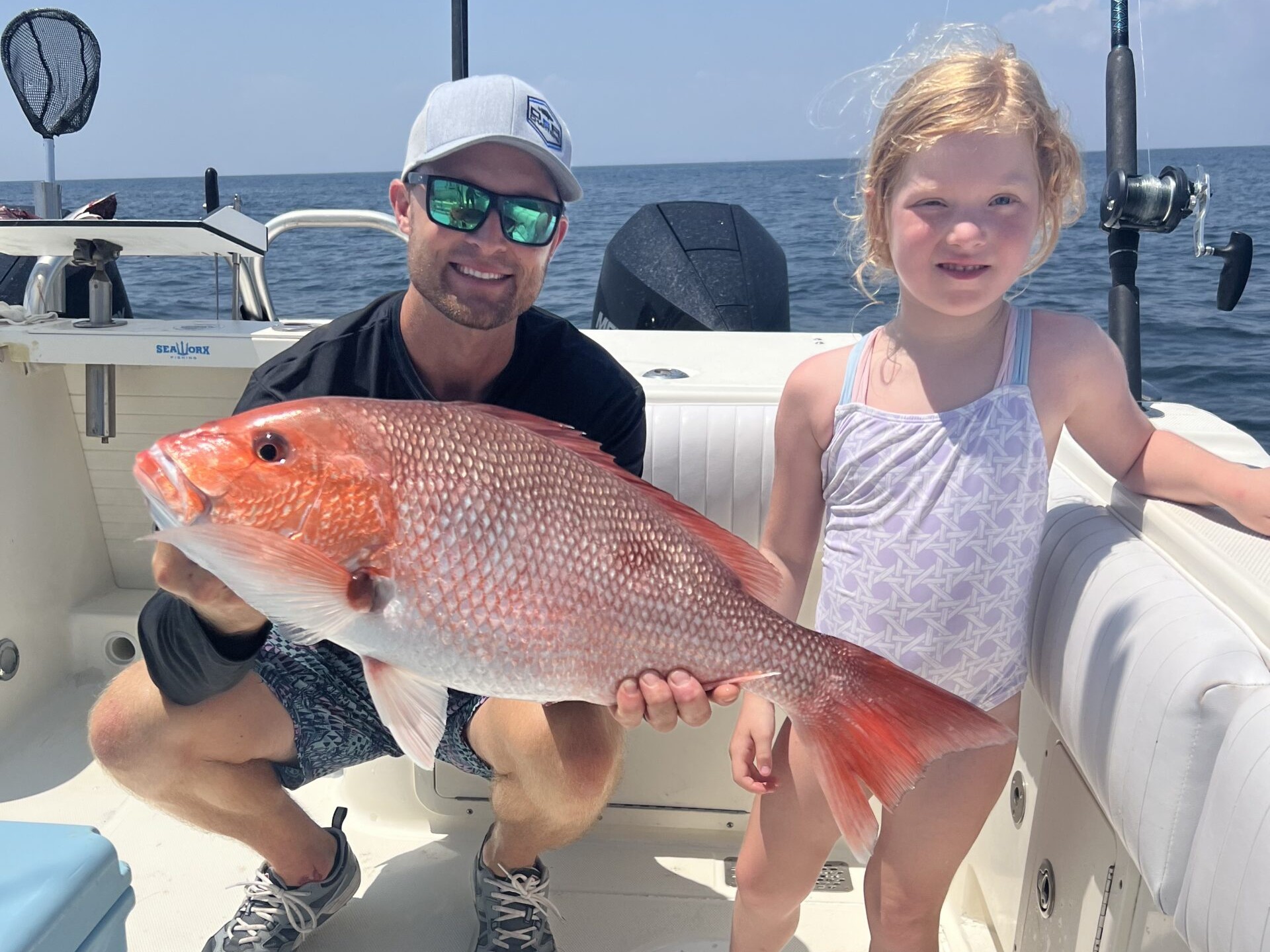 Father and daughter with a red snapper catch offshore